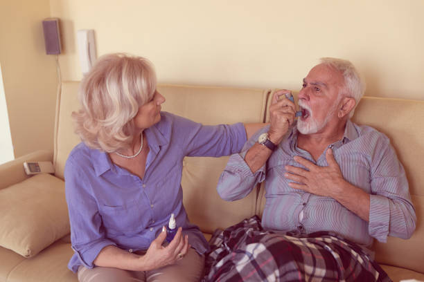 istock Senior Couple is Solving the Breathing Problems of an Older Man who is Using Inhaler. 1313805826