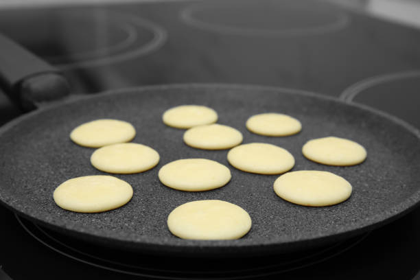 istock Frying tasty cereal pancakes on modern stove 1313805960