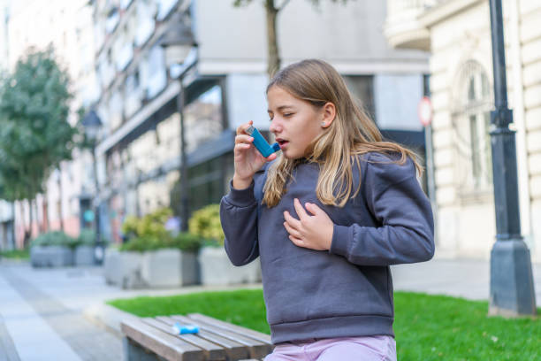 istock Asthmatic Little Girl is Using a Smoke Inhaler in a Park. 1313805993