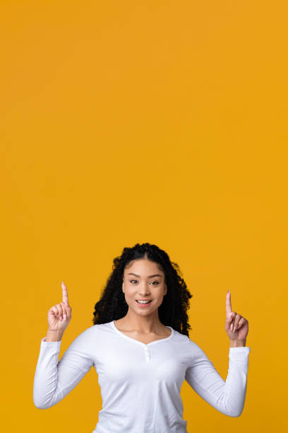 istock Look There. African Lady Pointing Up At Copy Space Above Her Head 1313806164