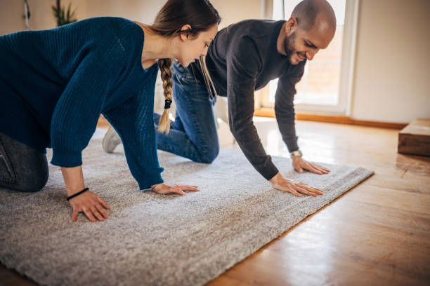 istock Couple putting carpet in their new apartment 1313807097