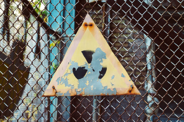 Old radiation sign on wire fence in Chernobyl Exclusion Zone, Ukraine Old radiation sign on wire fence in Chernobyl Exclusion Zone, Ukraine abandoned place stock pictures, royalty-free photos & images