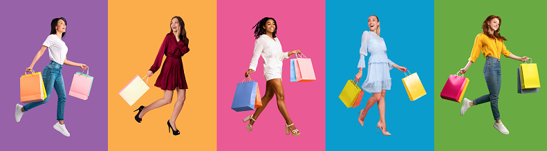 Seasonal Shopping Concept. Full body length collage of diverse multicultural female consumers walking and jumping high with shopping bags from mall, isolated over colorful studio backgrounds, panorama