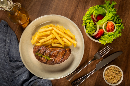 Grilled steak with french fries and brazilian farofa.