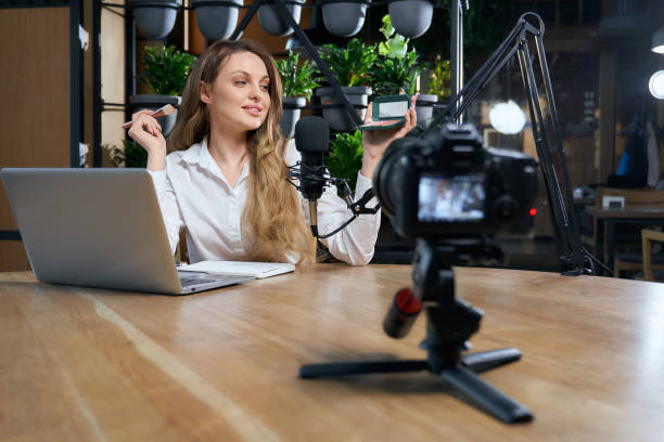 istock Blogger woman preparing for interview on camera in cafe. 1313813853