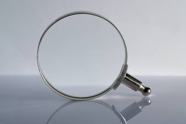 istock magnifying glass seen in front on white background 1313814006