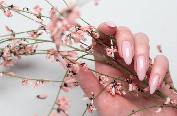 istock Beautiful female hands with pink manicure 1313814216