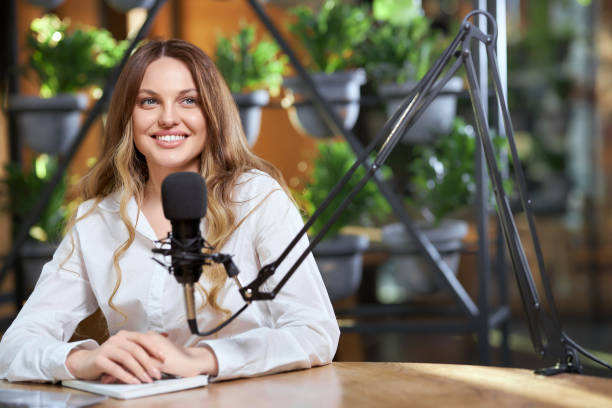 istock Pretty woman giving interview with microphone online. 1313814871