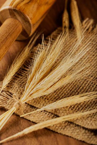 istock Ears of wheat on wooden background. 1313815201