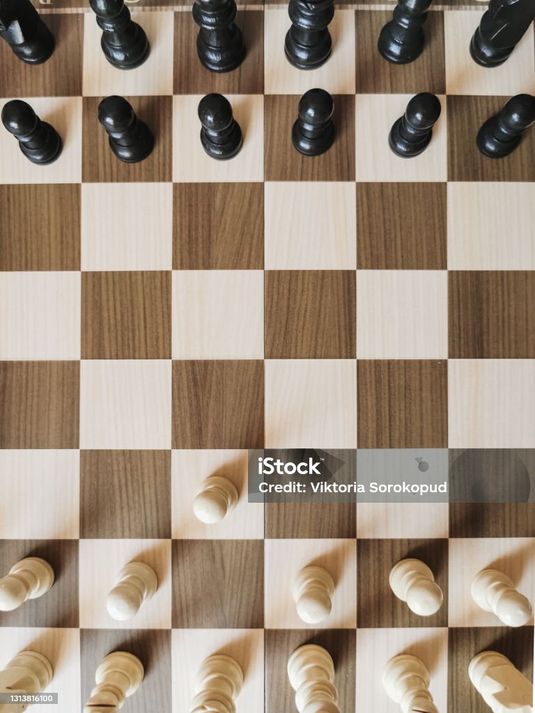 top view of a chessboard with spaced figures chess pieces are placed on the game board for playing Chess Stock Photo