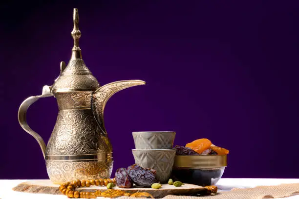 Eid and Ramadan set with Arabian coffee and dates set in dark background. Festive greeting card, an invitation for Muslim holy month Ramadan Kareem or Eid al Adha and Eid al fiter