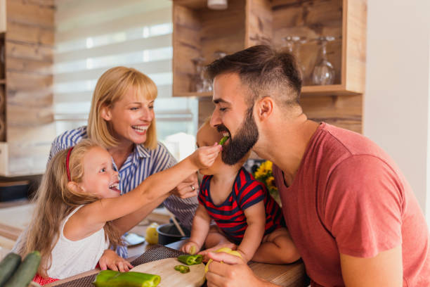 istock Daughter feeding father with vegetables 1313817580