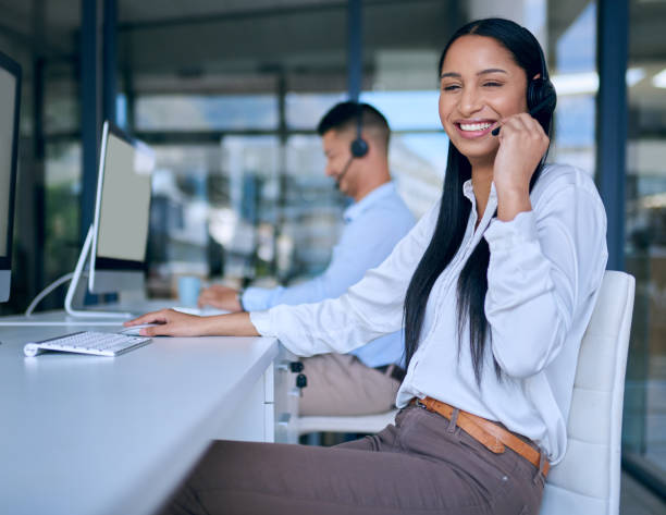 istock Shot of a young woman using a headset and computer in a modern office 1313820952