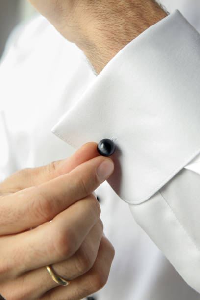 istock Groom putting on cufflinks as he gets dressed 1313821545