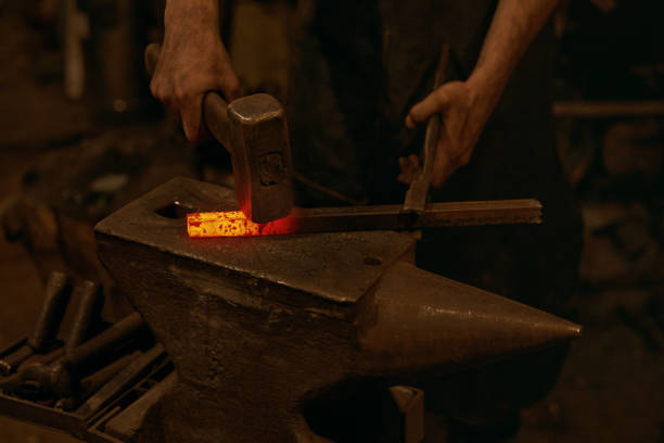 istock Blacksmith treatment molten iron metal in smithy 1313822077