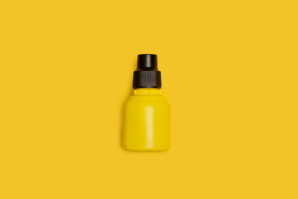 istock A yellow and black small plastic bottle on a yellow background 1313822331