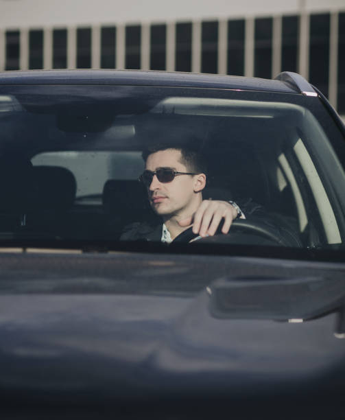 istock man in glasses seating in car 1313823222