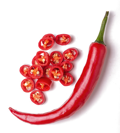 Hot chili pepper whole and slices isolated on white background.