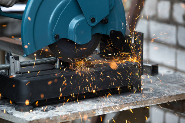 istock Iron pipe cutting saw for metal with bright sparks close up. 1313828110