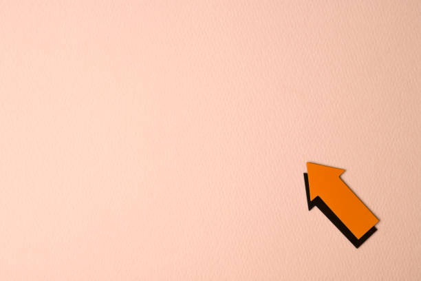 istock orange arrow on pink background 1313828975