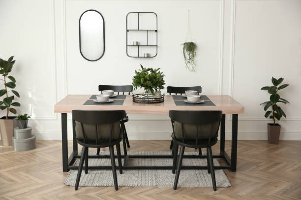 istock Stylish wooden dining table and chairs in room. Interior design 1313830497