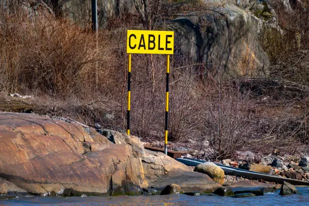 Helsinki / Finland - APRIL 16, 2021: Closeup of a warning sign indicating under-the-sea cable route.
