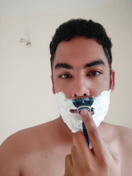 istock Shaving process of a indian men 1313832828