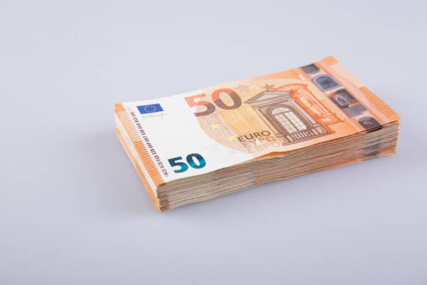 istock A stack of clear 50 euro banknotes on a gray background. 1313834328