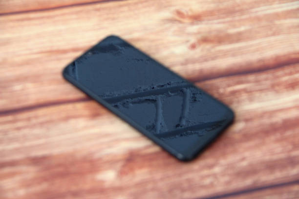 istock Smartphone with a black screen in which a brick wall is reflected on the wooden background, selective focus 1313835361