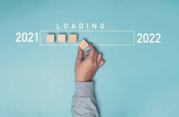 istock Hand putting wooden cube block with infographic loading from 2021 to 2022 on blue background , Preparation Merry Christmas and happy new year concept. 1313836623