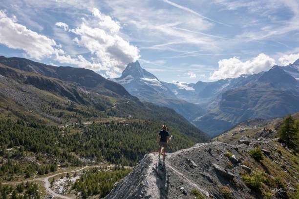 istock Man contemplates the Matterhorn peak from mountain top 1313837067