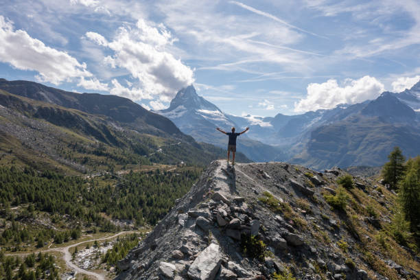 istock Man contemplates the Matterhorn peak from mountain top 1313837168