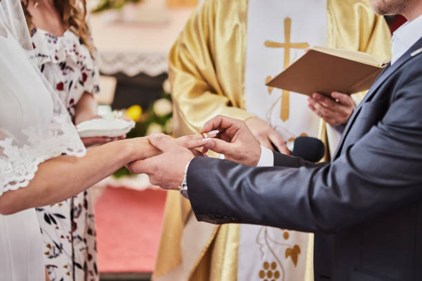 brautpaar tauscht ringe während einer hochzeit in einer katholischen kirche - katholizismus stock-fotos und bilder