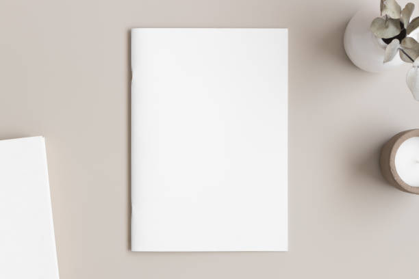 istock Magazine mockup with a book, candle and a  eucalyptus on the beige table. 1313842660
