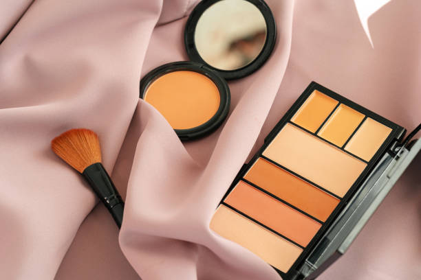 istock Make up foundation and face powder on pink silky cloth 1313842819
