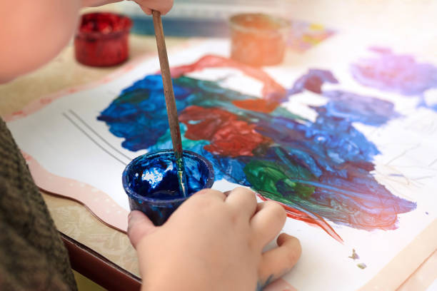istock A little boy paints with gouache coloring. 1313844773