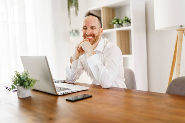 istock Nice mature man working on laptop at home 1313847038