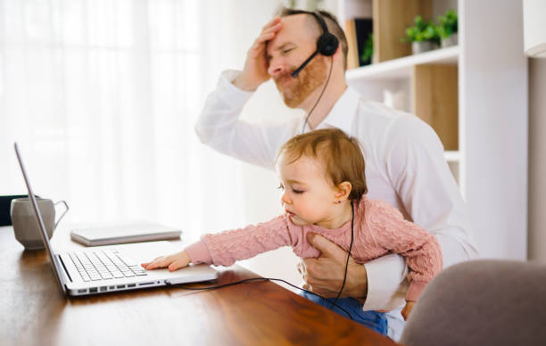 istock sad and frustrated father in kitchen home office with computer and her daugher 1313847078