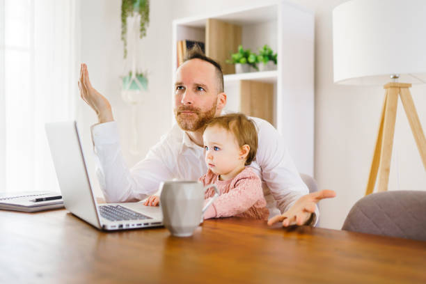 istock sad and frustrated father in kitchen home office with computer and her daugher 1313847227