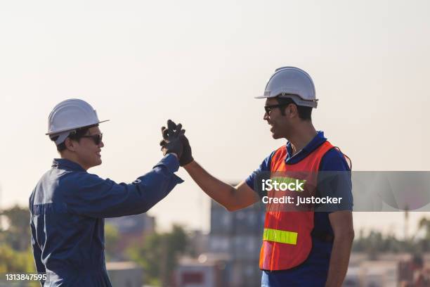 Engineer And Worker Soul Brother Handshake Thumb Clasp Handshake Or Homie Handshake Happy Foreman Team Join Hands Together Success And Teamwork Concepts Stock Photo - Download Image Now
