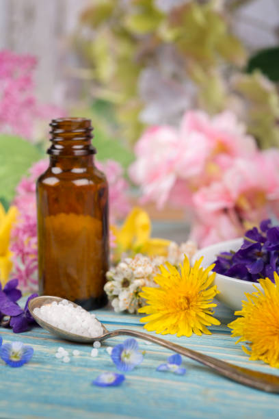 istock Homeopathy globules and blossoms on a table with spoon and globules 1313849890