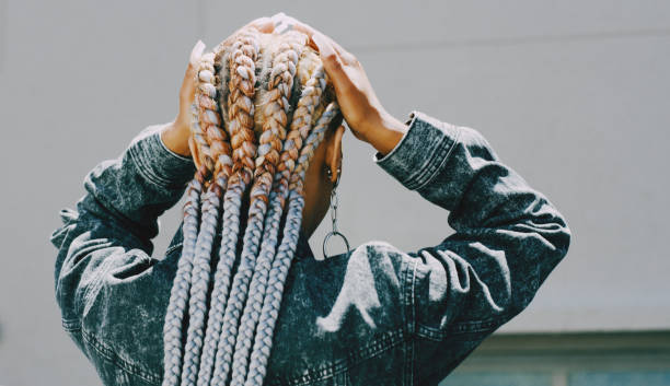 istock Rearview shot of a woman with cornrows posing outside 1313851986