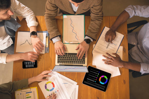 istock Top view, close up. Colleagues working together in modern office using devices and gadgets during creative meeting 1313853495
