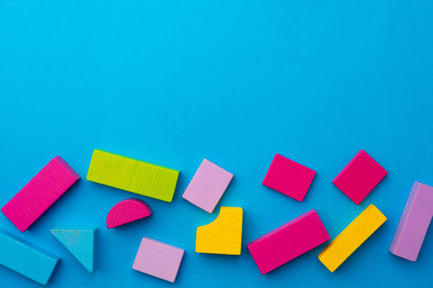 istock Multicolored pieces of toy constructor on blue background 1313854932