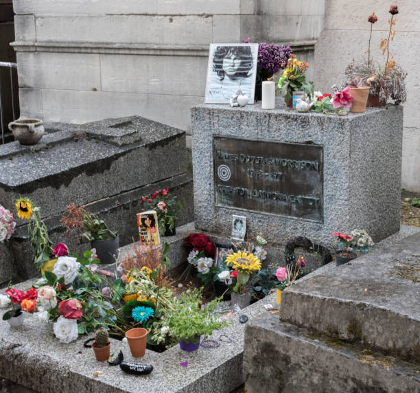 Jim Morrison grave in Pere-Lachaise cemetery in Paris, France. Fans and curious visitors come to pay homage to Jim Morrison's the vocalist of the Doors stock photo