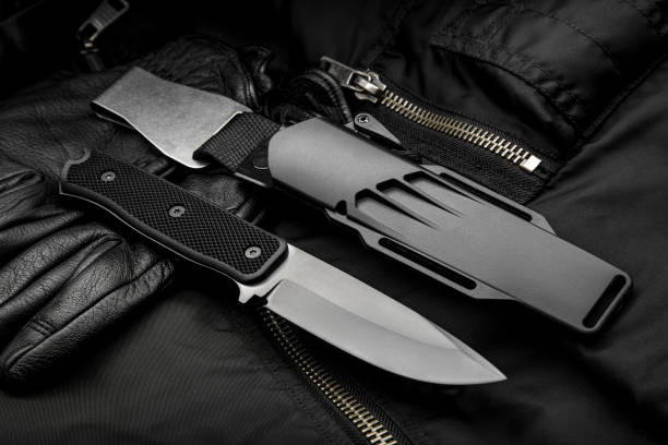 istock A modern hunting knife with a rubberized handle and a plastic sheath on a dark background. Melee weapons for self-defense and survival. 1313856116
