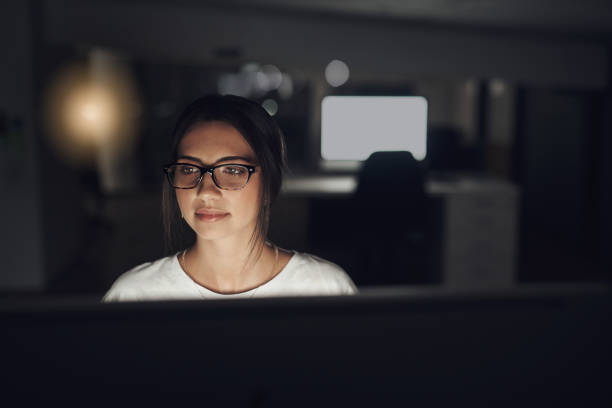 istock Shot of a young businesswoman using a computer in a modern office at night 1313856466