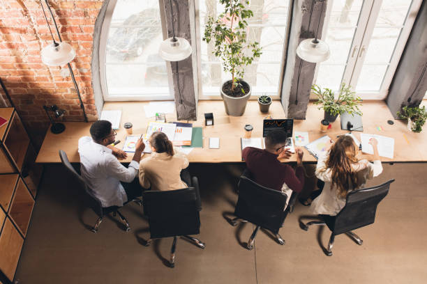 istock Colleagues working together in modern office using devices and gadgets during negotiations. Top view. 1313861187