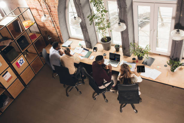 istock Colleagues working together in modern office using devices and gadgets during negotiations. Top view. 1313861197