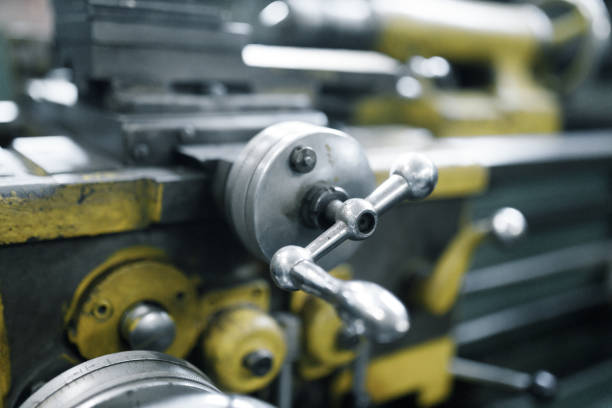 Lathe close-up, metal with a blurred background. Old locksmith lathe, components and tools.